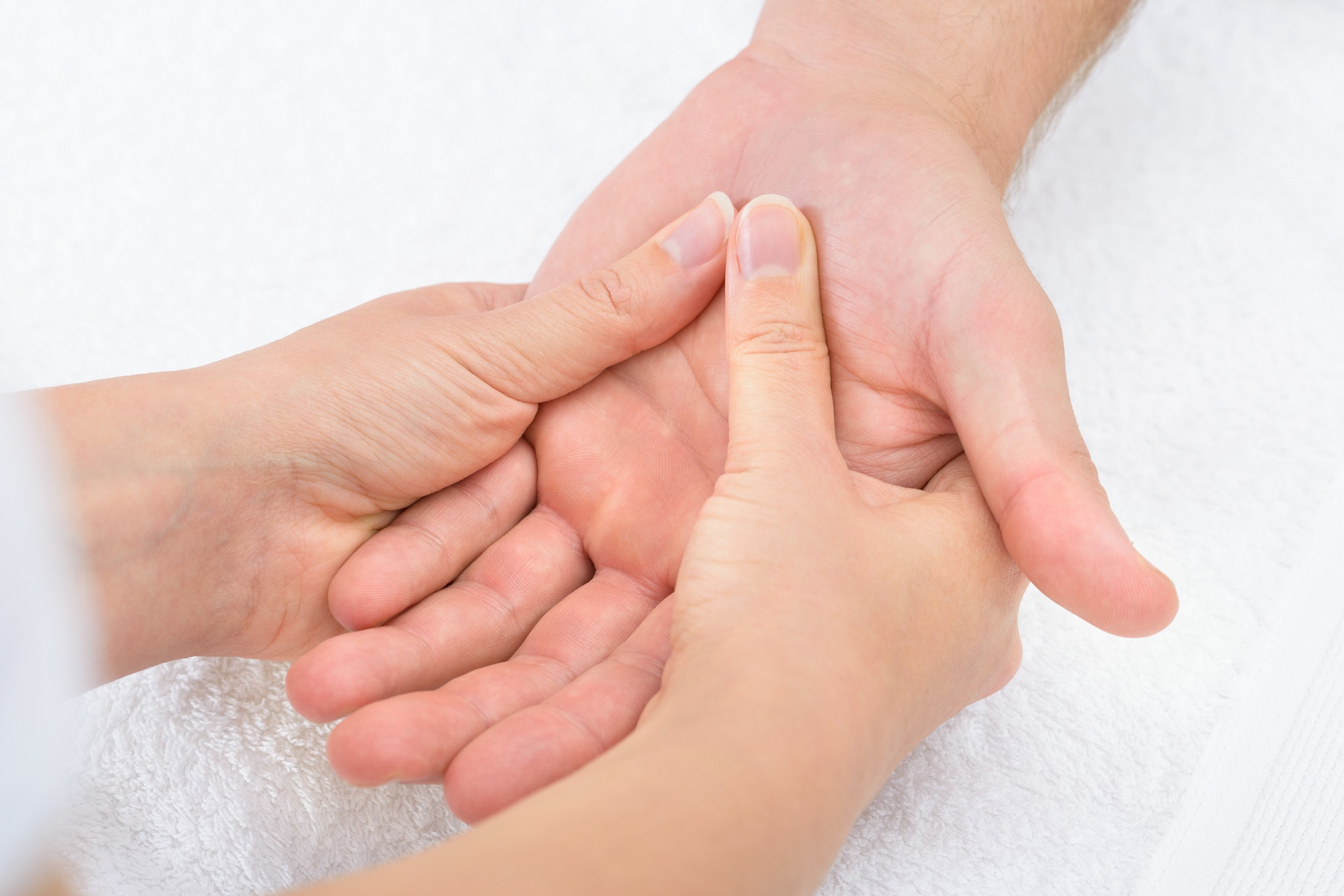 Close-up Of A Physiotherapist Massaging Palm Of A Man